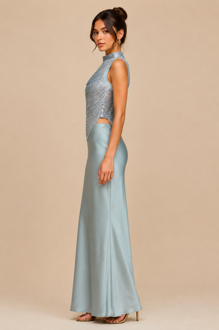 Woman wearing a light blue evening gown with a beige background