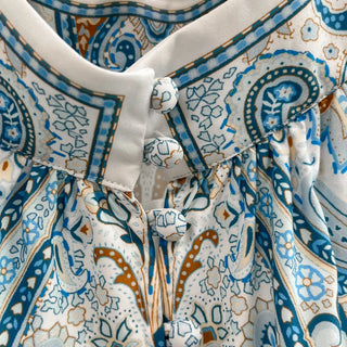 Close-up of a patterned fabric with blue, white, and orange colors.