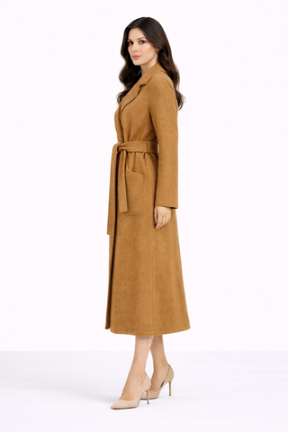 Woman wearing a long brown coat on a white background