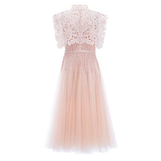 A sleeveless high-neck tulle dress in a soft blush pink color, featuring a lace bodice and a layered tulle skirt, shown against a plain white background.