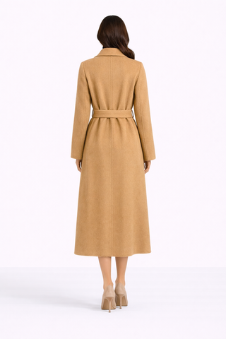 Woman wearing a long beige coat on a white background