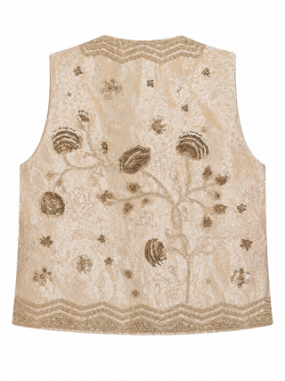 A beige sleeveless embroidered vest featuring intricate metallic gold floral and vine patterns, with decorative zigzag borders at the neckline and hem, shown against a plain white background.