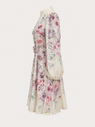 Romantic floral mini dress featuring a watercolor floral print in pink, lavender, lilac, and ivory tones, high neckline, long sleeves, matching waist belt, fit and flare silhouette, and flowing lightweight fabric, perfect for wedding guests, baby showers, bridal showers, garden parties, brunches, and elegant spring or summer occasions.