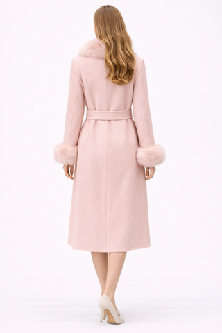 Woman wearing a pink coat on a white background