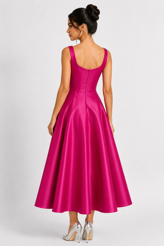 Woman wearing a pink satin dress on a white background