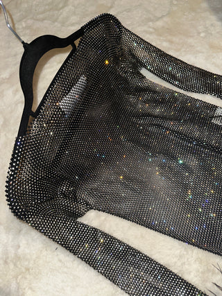 Black mesh lingerie set on a beige surface