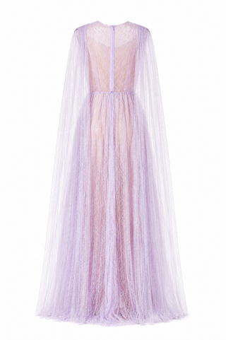 A lavender purple tulle maxi dress with a sheer lace bodice and a long flowing cape-style overlay, shown from the back on a white background.