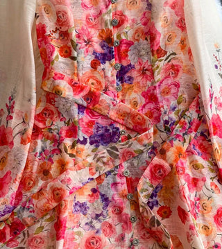 Romantic floral mini dress featuring a colorful pink and coral floral print, sheer long sleeves, high neckline, decorative front buttons, removable waist tie belt, fit and flare silhouette, and fully lined design, perfect for wedding guests, baby showers, garden parties, bridal showers, and elegant spring and summer occasions.zimmermann style inspired dupe