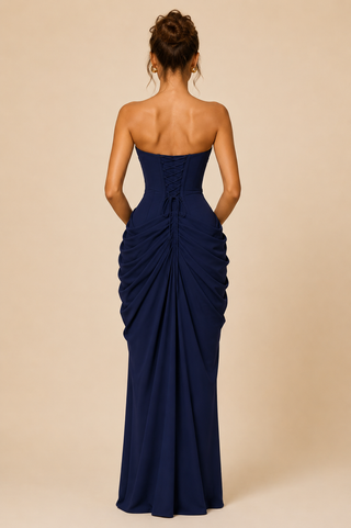 Navy strapless gown with ruched design on a beige background