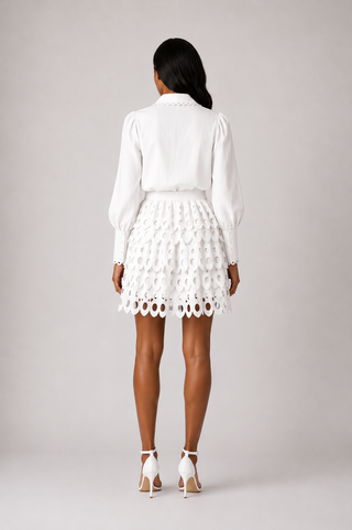 White eyelet embroidered blouse and matching skort set with built-in shorts, scalloped detailing and feminine tailoring, perfect for bridal showers, bachelorette parties, white parties, summer vacations, graduations and elegant daytime events.