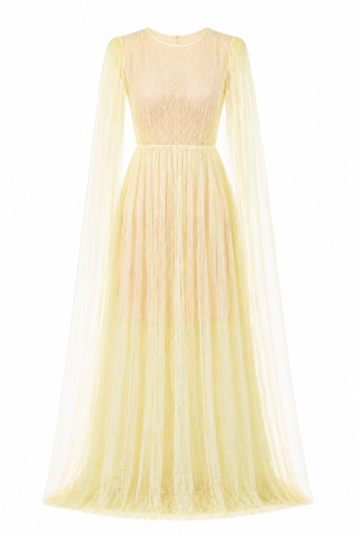 A pale yellow lace and tulle maxi dress with long sheer cape sleeves, a round neckline, and a full flowing skirt, shown on a plain white background.
