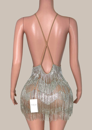 Silver fringe dress on a mannequin with a beige background