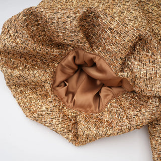 Close-up of a textured brown hat on a white background