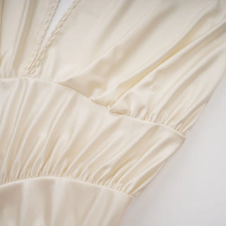 Close-up of a beige fabric with a subtle pattern on a light background