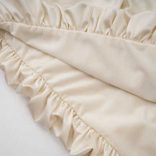 Close-up of beige ruffled fabric on a white background