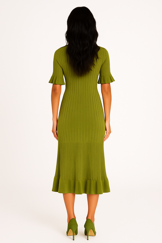 Woman wearing a green ribbed dress on a white background