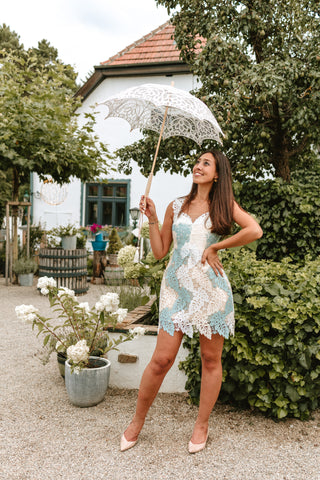 Model wearing a soft blue and ivory mini lace dress with a floral overlay, perfect for summer parties and elegant events by Cielie.