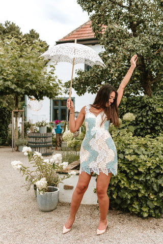 Model wearing a soft blue and ivory mini lace dress with a floral overlay, perfect for summer parties and elegant events by Cielie.