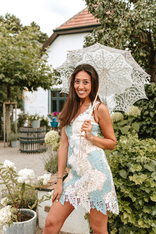 Model wearing a soft blue and ivory mini lace dress with a floral overlay, perfect for summer parties and elegant events by Cielie.