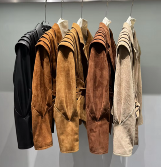 Premium wild leather goatskin suede jackets with pleated shoulder detailing, available in tan, rust brown, beige, and black, hanging on a clothing rack with adjustable belted waists for a tailored fit. Drejani Leather Jacket Suede, Wildleather Jacket