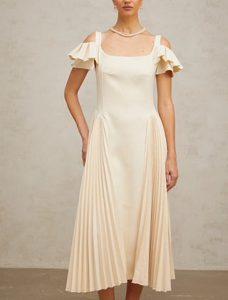 Woman wearing a neutral pleated midi dress with flutter sleeves and darted bodice, ideal for elegant summer events, wedding guest looks, or garden parties.