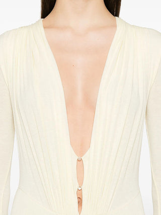Close-up of a beige dress with a deep neckline on a white background
