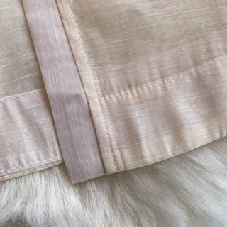 Close-up of beige fabric with a textured pattern on a fur surface