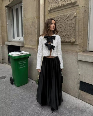 White sequin party top with black bow details