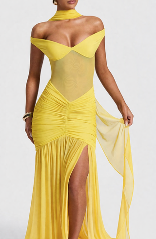 Yellow evening gown with sheer panels on a white background