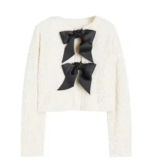 White sequin party top with black bow details