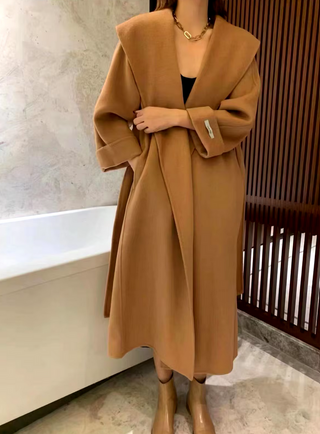 Stylish camel cashmere wool coat with a belted waist and large lapel, showcasing its elegant double-sided design. Camel Max Mara Style Belted 