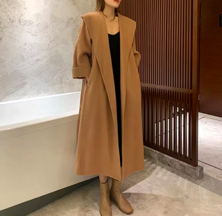 Stylish camel cashmere wool coat with a belted waist and large lapel, showcasing its elegant double-sided design. Camel Max Mara Style Belted 