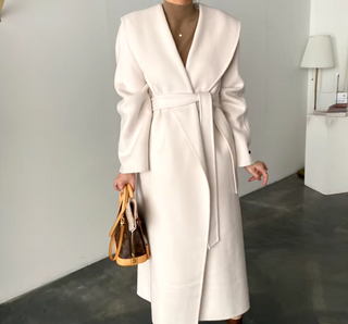 Elegant white cashmere wool coat with a belted waist and large lapel, showcasing its double-sided design. Max MaraCoat similar dupe