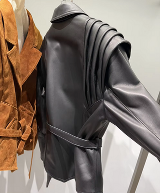 Premium wild leather goatskin suede jackets with pleated shoulder detailing, available in tan, rust brown, beige, and black, hanging on a clothing rack with adjustable belted waists for a tailored fit. Drejani Leather Jacket Suede, Wildleather Jacket Real Leather