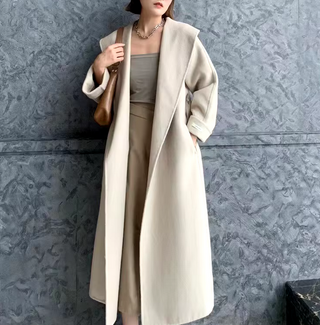 Elegant white cashmere wool coat with a belted waist and large lapel, showcasing its double-sided design. Max MaraCoat similar dupe