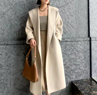 Elegant white cashmere wool coat with a belted waist and large lapel, showcasing its double-sided design. Max MaraCoat similar dupe