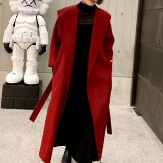 Model wearing a dark red cashmere wool coat, featuring a belted style and versatile design suitable for both casual and formal occasions.