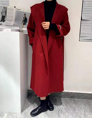 Model wearing a dark red cashmere wool coat, featuring a belted style and versatile design suitable for both casual and formal occasions.