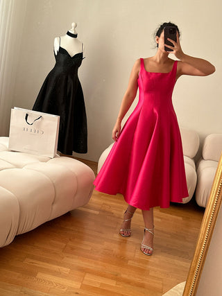 Minimalistic flared pink A Line cocktail dress with square neckline available in various colors, perfect for elegant events or cocktail dress rental in Vienna.