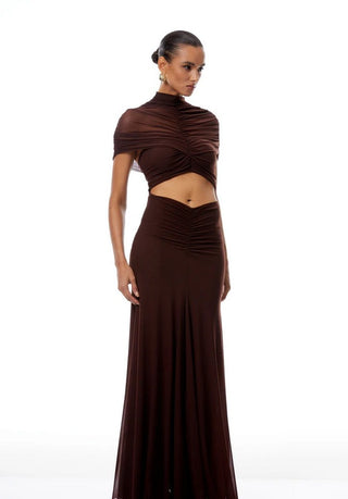 Woman wearing a brown dress with cut-out design on a white background