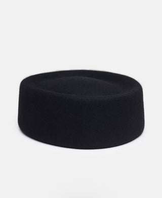 Black hockey puck on a white background