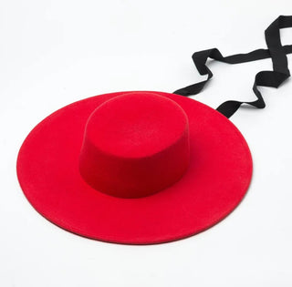 Red hat with a black ribbon on a white background