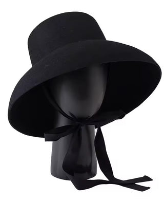Black wide-brimmed hat with a ribbon on a mannequin head against a white background