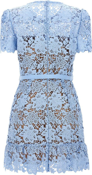 Model wearing Isola baby blue guipure lace mini dress with floral appliqué and belted waist