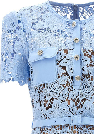Model wearing Isola baby blue guipure lace mini dress with floral appliqué and belted waist