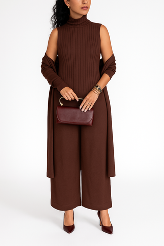 Woman wearing a brown sleeveless dress with wide-leg pants on a white background