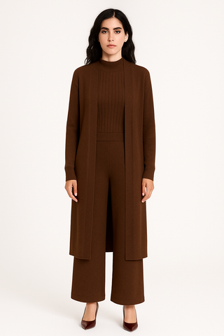 Woman wearing a brown outfit with a long coat and wide-leg pants on a white background
