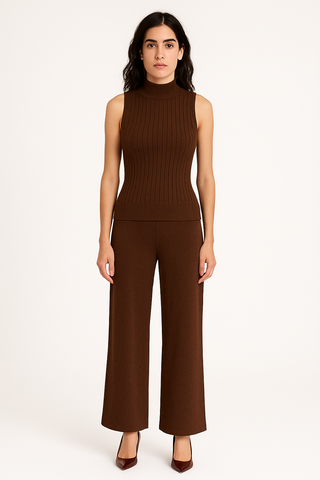 Woman wearing a brown sleeveless top and wide-leg pants on a white background