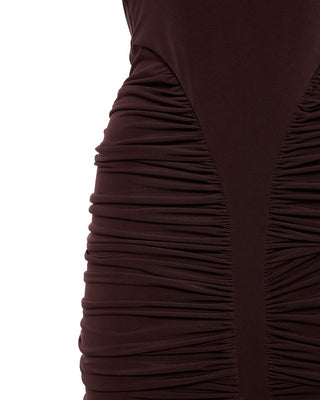 Close-up of a brown dress with pleated detailing on a white background