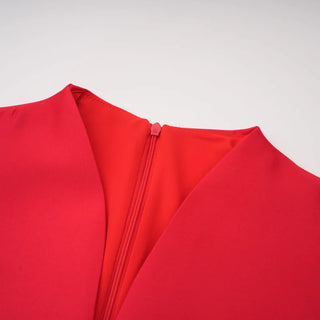 Close-up of a red garment with a zipper on a light gray background